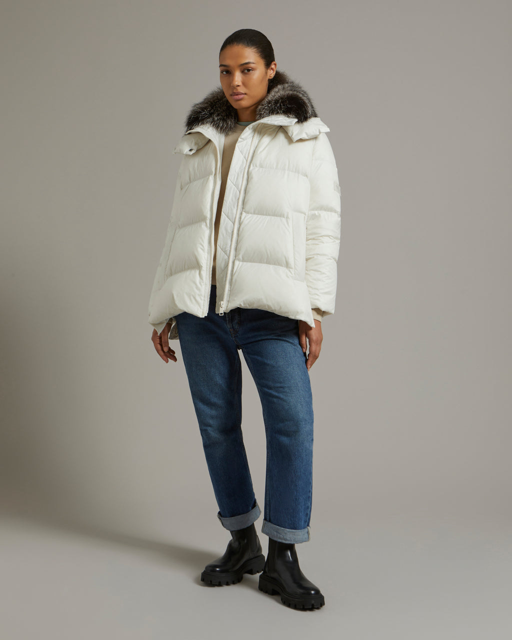 A line down jacket in water-repellent technical fabric with fox fur collar