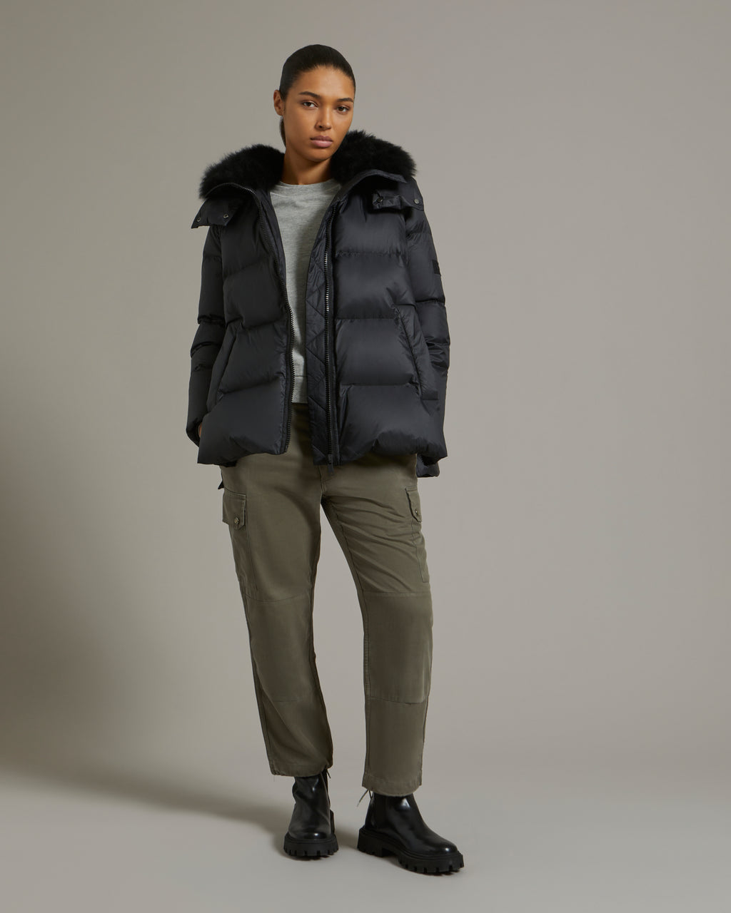 A line down jacket in water-repellent technical fabric with fluffy  lambswool collar