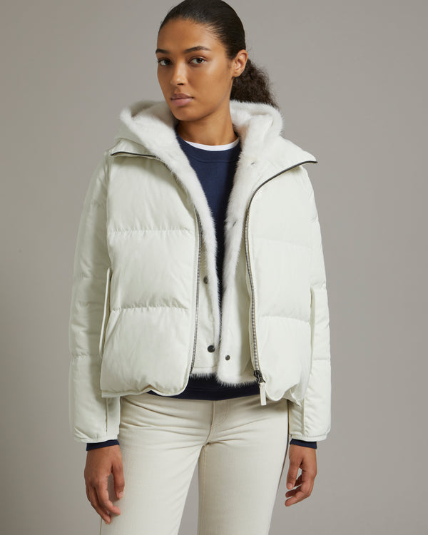A line down jacket in technical fabric with long-haired mink hooded bib