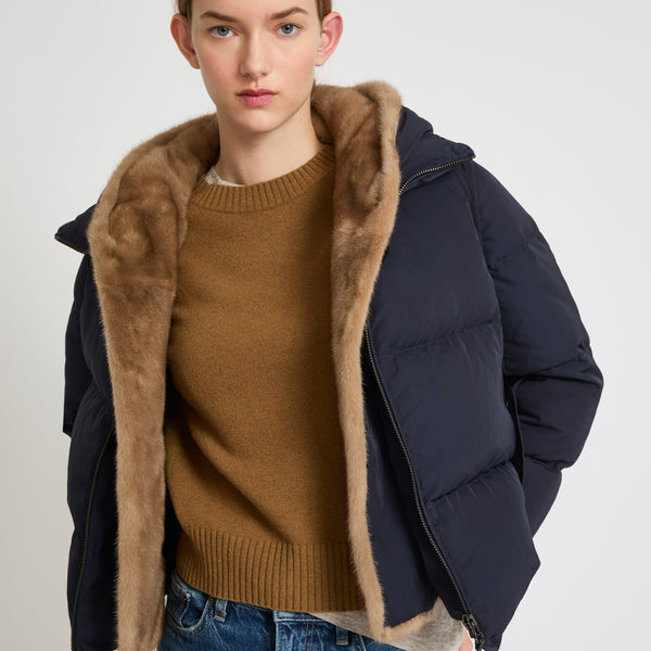 A line down jacket in technical fabric with long-haired mink hooded bib