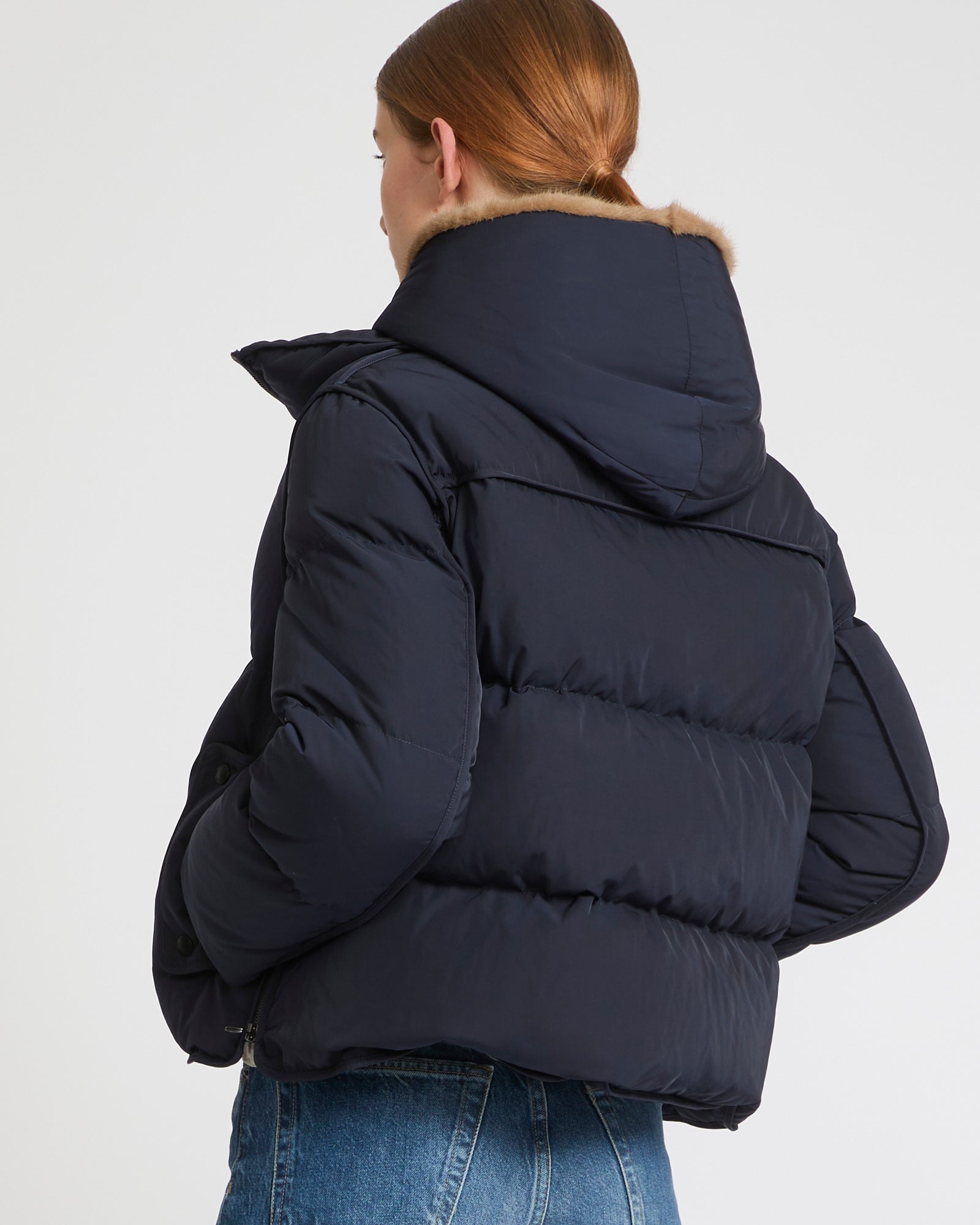 A line down jacket in technical fabric with long-haired mink hooded bib