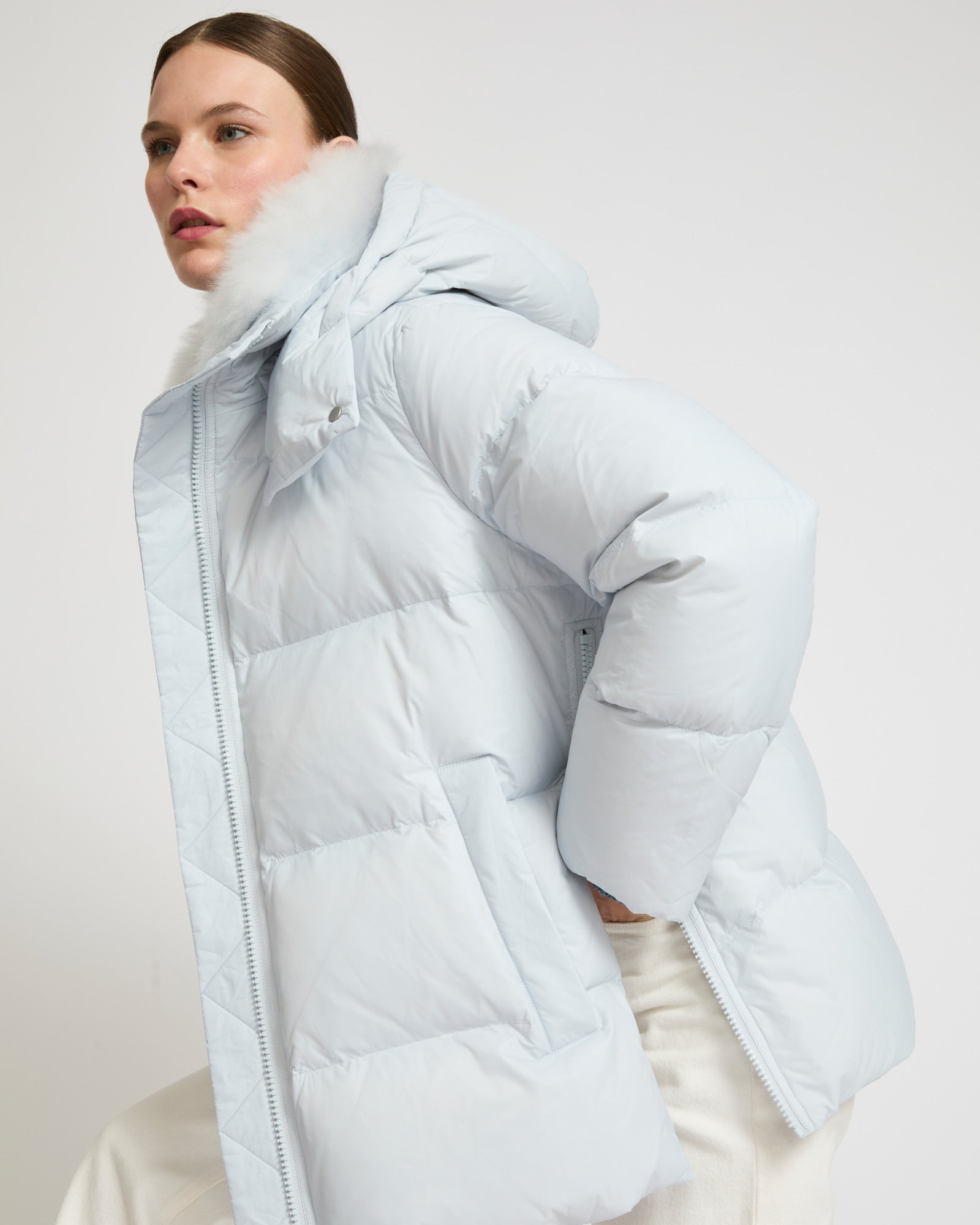 A line down jacket in water-repellent technical fabric with fluffy  lambswool collar