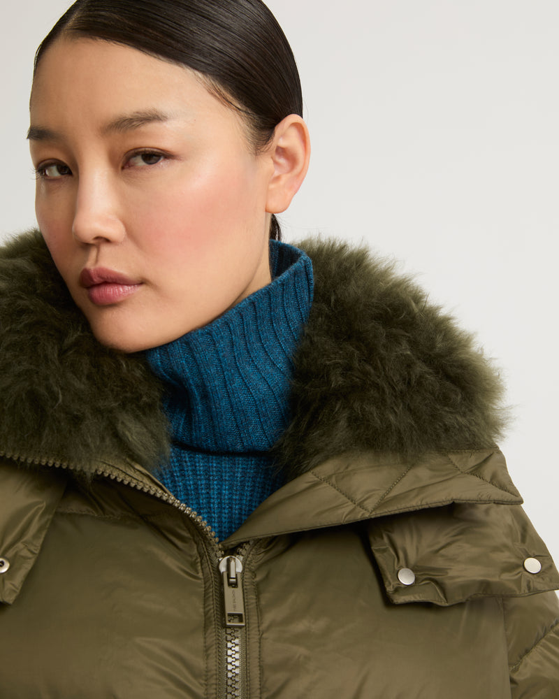 A line down jacket in water-repellent technical fabric with fluffy lambswool collar