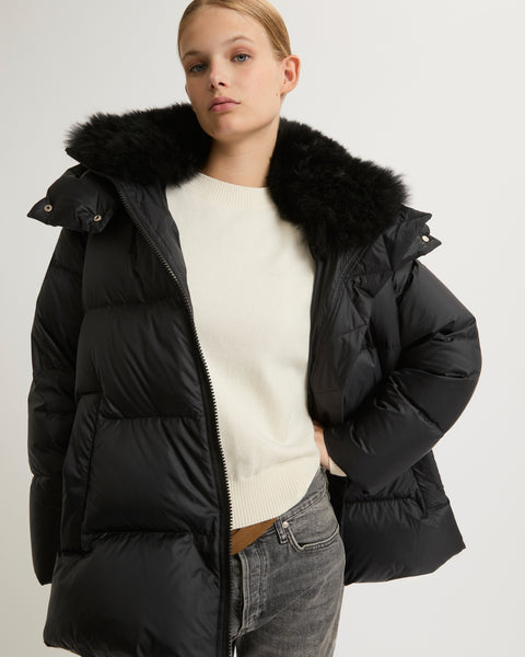 A line down jacket in water-repellent technical fabric with fluffy  lambswool collar