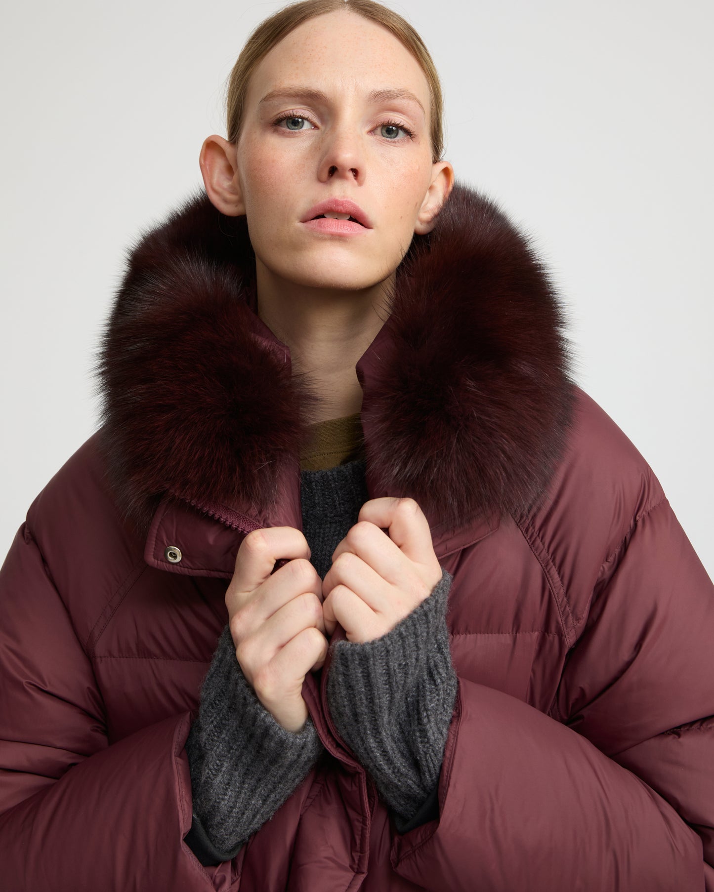Long down jacket with raglan sleeves and fox fur trim