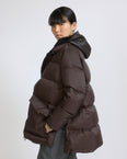 A-line down jacket in waterproof technical fabric with lambskin shearling bib panel