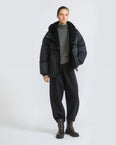 Short down jacket in waterproof technical fabric with lambskin shearling bib panel