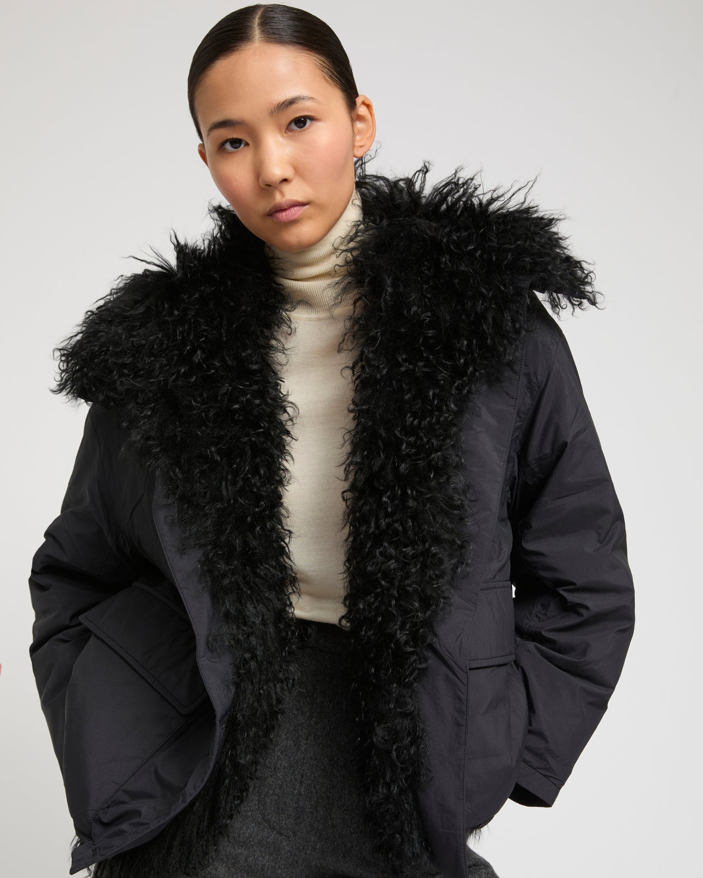 Short ultra-light down jacket with curly lambskin trim