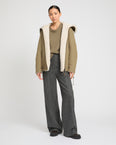 Reversible hooded jacket in lambskin shearling and technical fabric