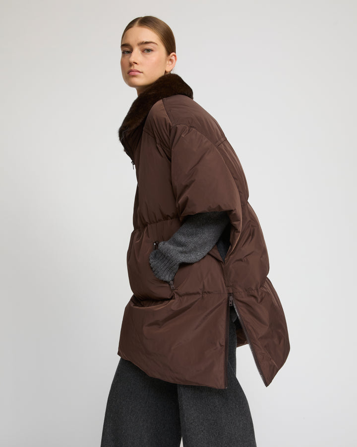 Technical fabric down cape with mink fur stand collar and lining.