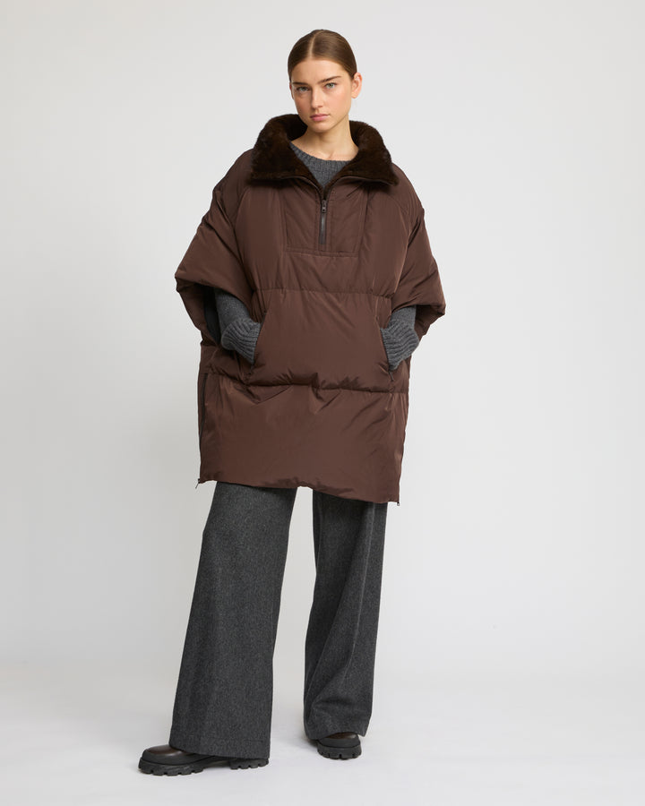 Technical fabric down cape with mink fur stand collar and lining.