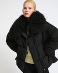 Down jacket in cashmere fabric with long curly lambskin collar
