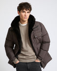 Down jacket in technical fabric with lambskin shearling bib panel
