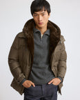 Down jacket in waterproof technical fabric with mink fur bib panel